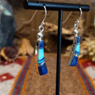 Flowing jewelry set with matching necklace, earrings, and cuff featuring lapis and manmade opal inlays.