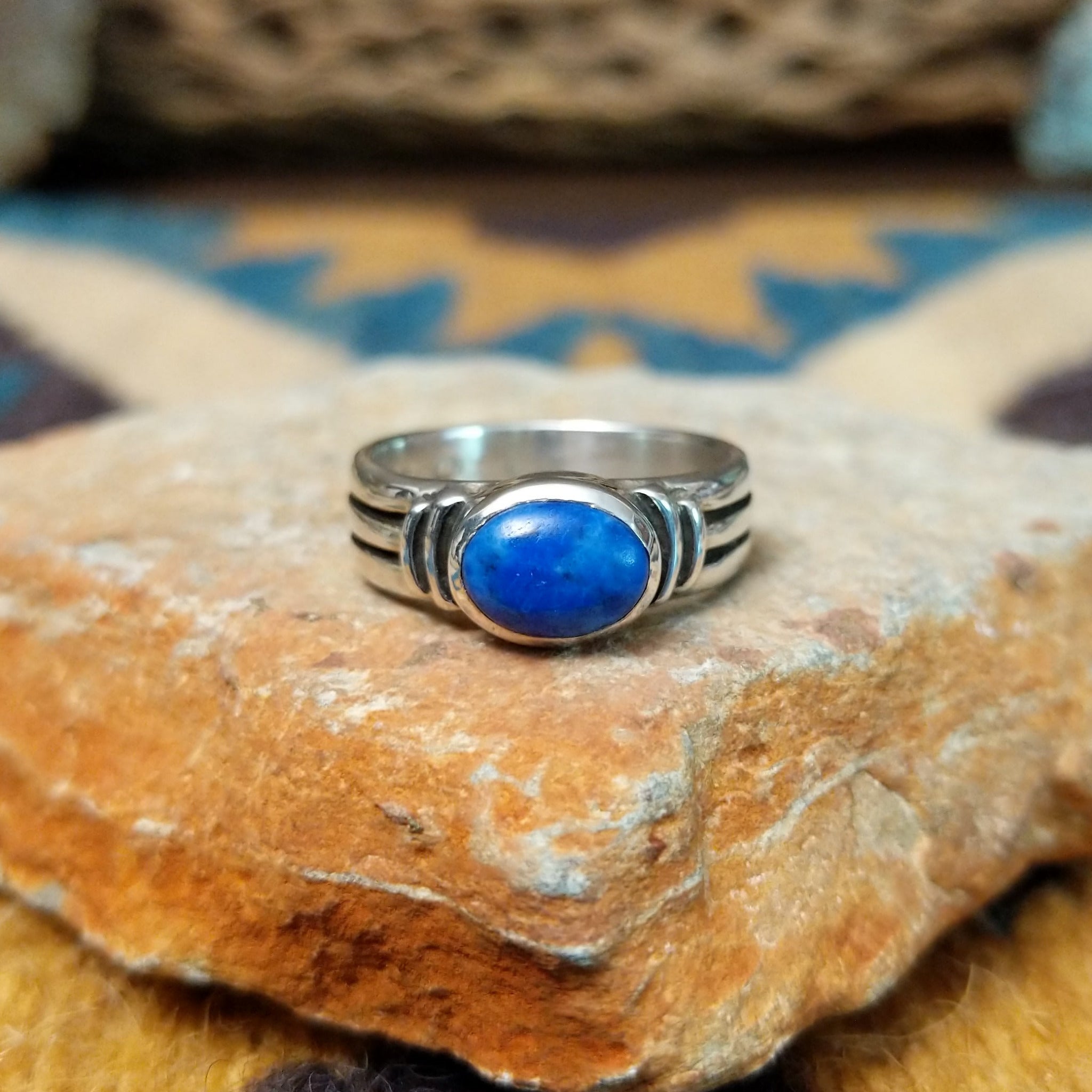 Handcrafted sterling silver Navajo lapis oval ring by D.C., featuring a rich blue oval lapis gemstone in a classic bezel setting.