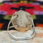 Navajo lapis ring by P. with oval blue stone, twisted silver border, and stamped details.Close up of the artist's stamped signature.