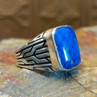 Sterling silver ring with lapis set in the rectangular bezel and geometric designs on the band.