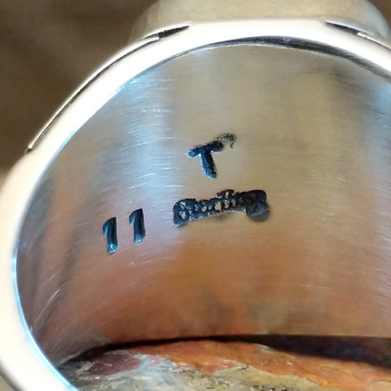 Close up of the artisan's stamped initials.