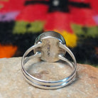This captivating Navajo Lapis Round Ring features a polished round royal-blue lapis stone with natural mineral markings, set in a simple silver bezel with an open split-shank band; Sterling Silver stamp.