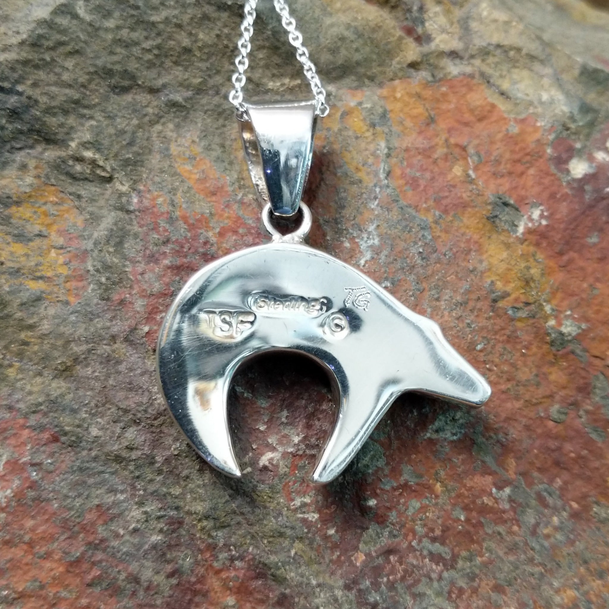 Handcrafted sterling silver lapis spirit bear pendant by T.G., featuring a traditional Navajo bear design; artisan and Sterling Silver stamp.