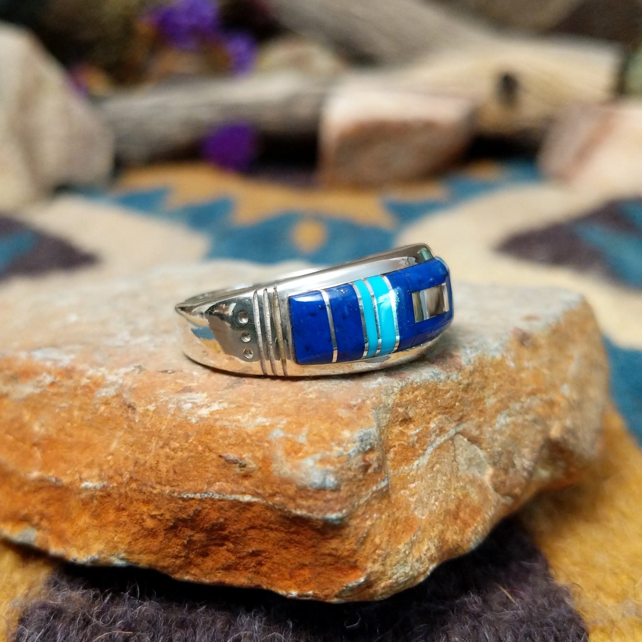 Sterling silver Navajo inlay ring with Lapis Lazuli, Turquoise, and geometric accents; side view.