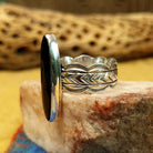 Navajo long black onyx ring, featuring an elongated black onyx stone set in a handcrafted sterling silver ring with an intricately detailed band.  Side view.