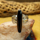 Navajo long black onyx ring, featuring an elongated black onyx stone set in a handcrafted sterling silver ring with an intricately detailed band.