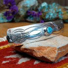Sterling silver Navajo barrette with stamped detailing and centered turquoise stone.