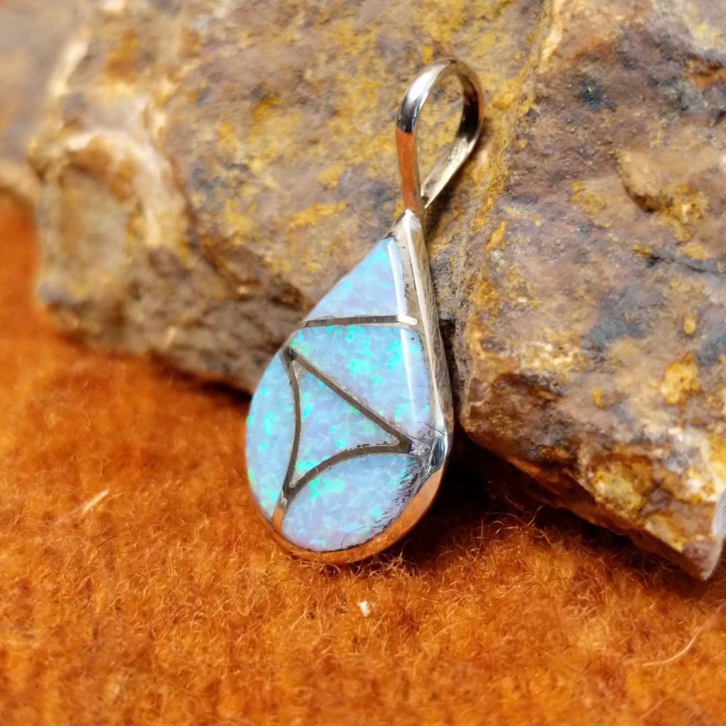 Blue manmade opal pendant inlaid in sterling silver.