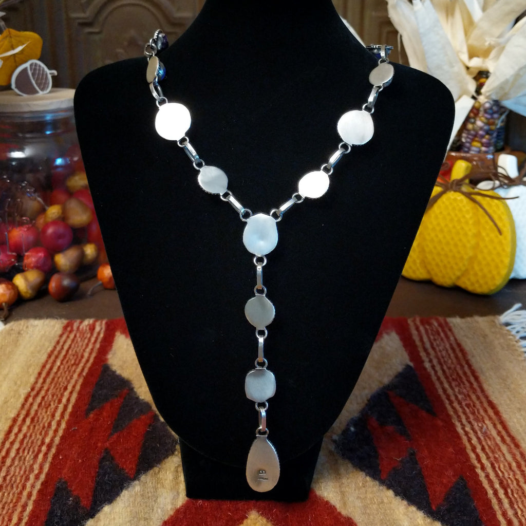 The back of the sterling silver bezels on the necklace.