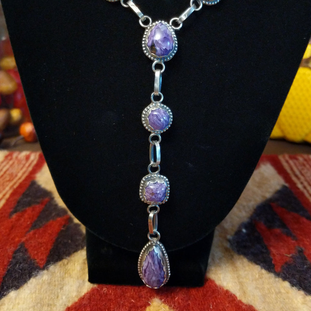 Charoite set in notched sterling silver bezels linked together to create the necklace.