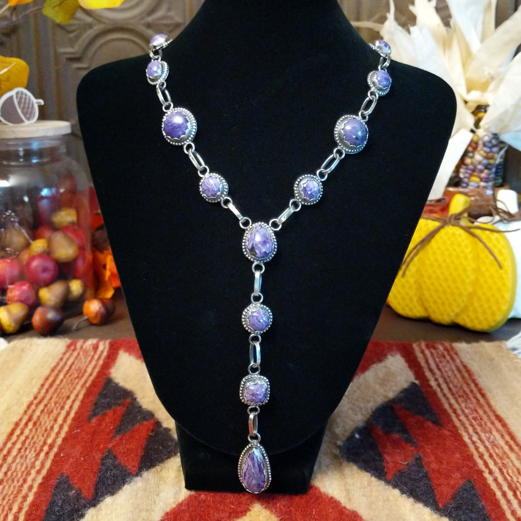 Charoite set in notched sterling silver bezels linked together to create the necklace.