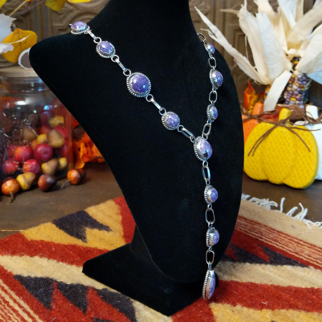 Charoite set in notched sterling silver bezels linked together to create the necklace.