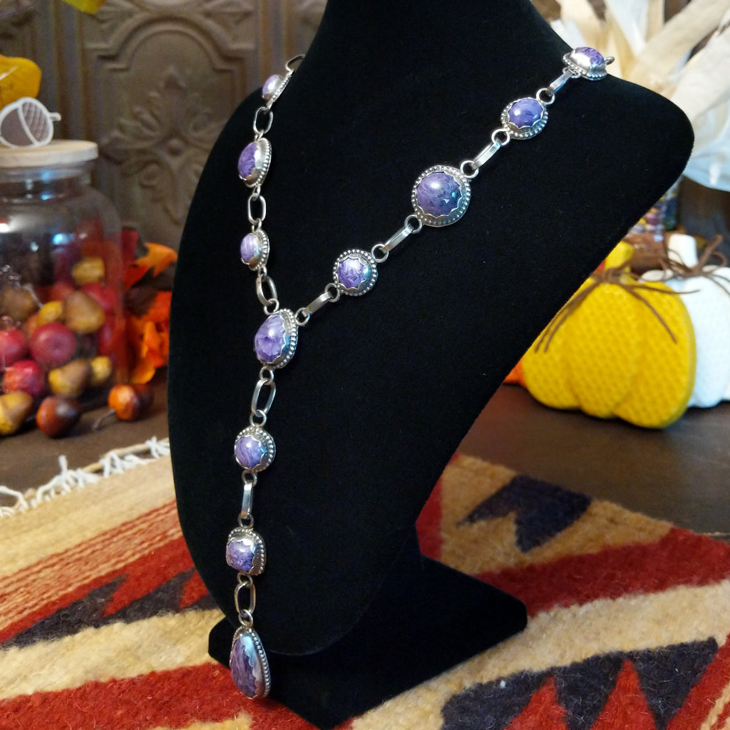 Charoite set in notched sterling silver bezels linked together to create the necklace.