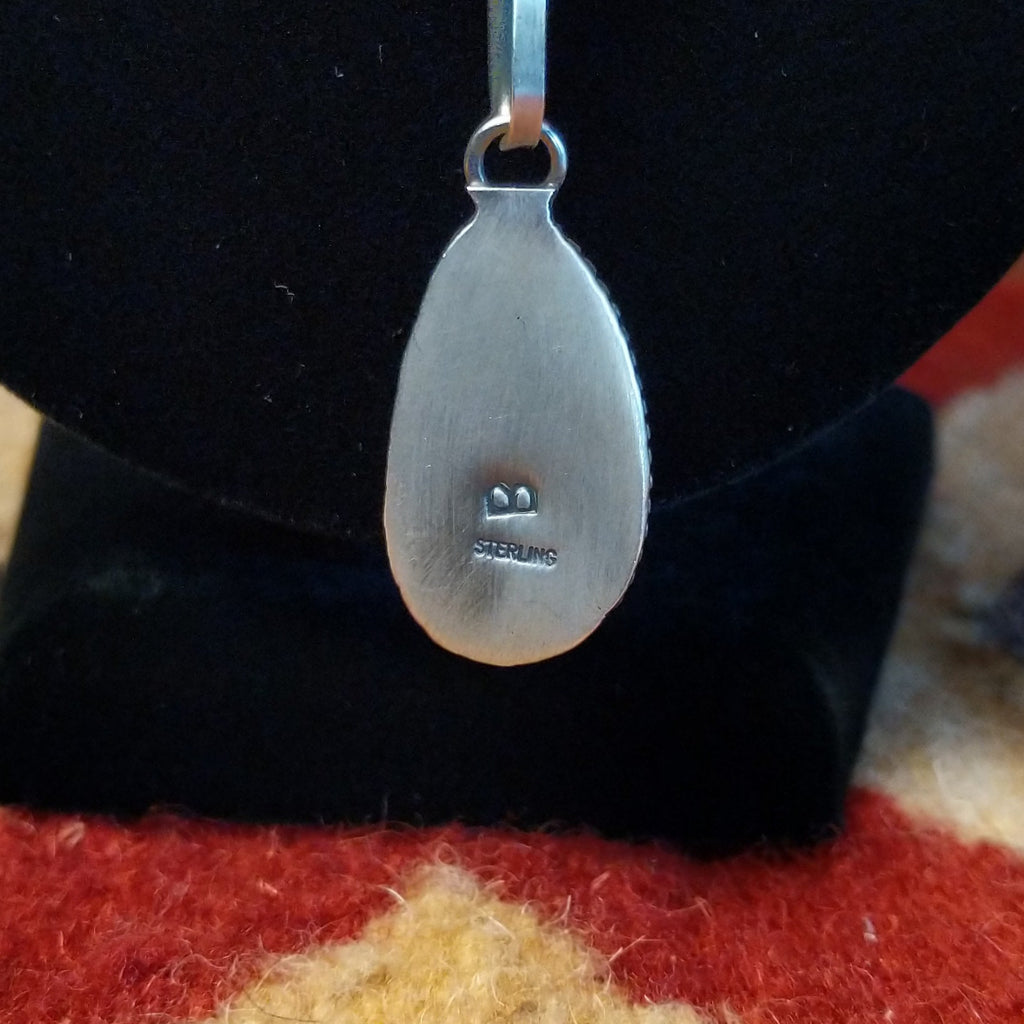 A close-up of the stamped authentication and initial.