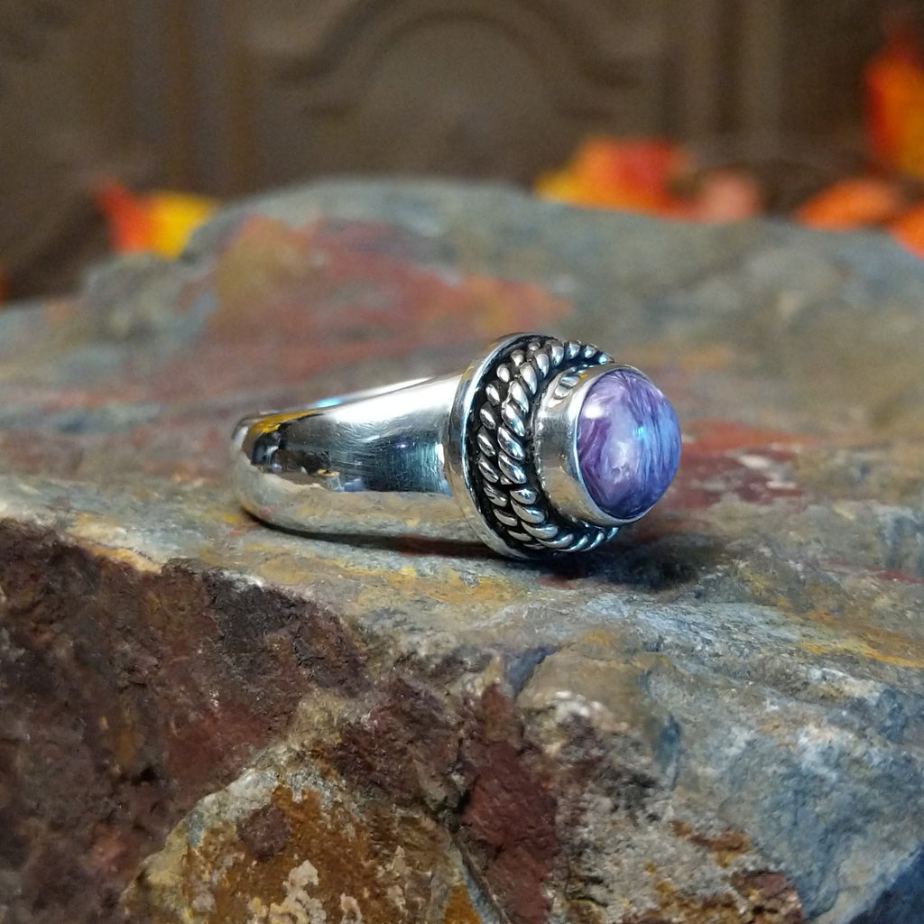 Charoite set in sterling silver bezel with twisted rope accents creating the centerpiece of the ring.