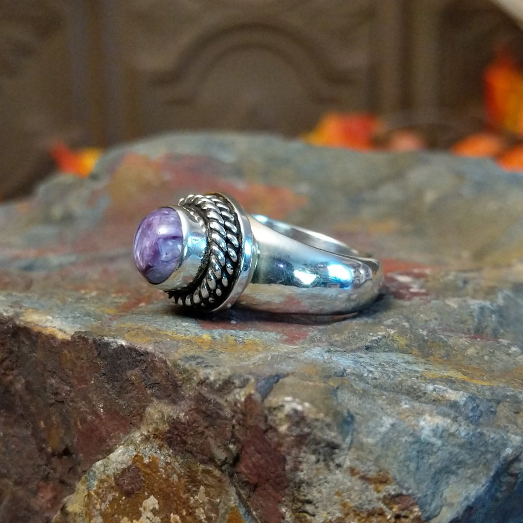 Charoite set in sterling silver bezel with twisted rope accents creating the centerpiece of the ring.