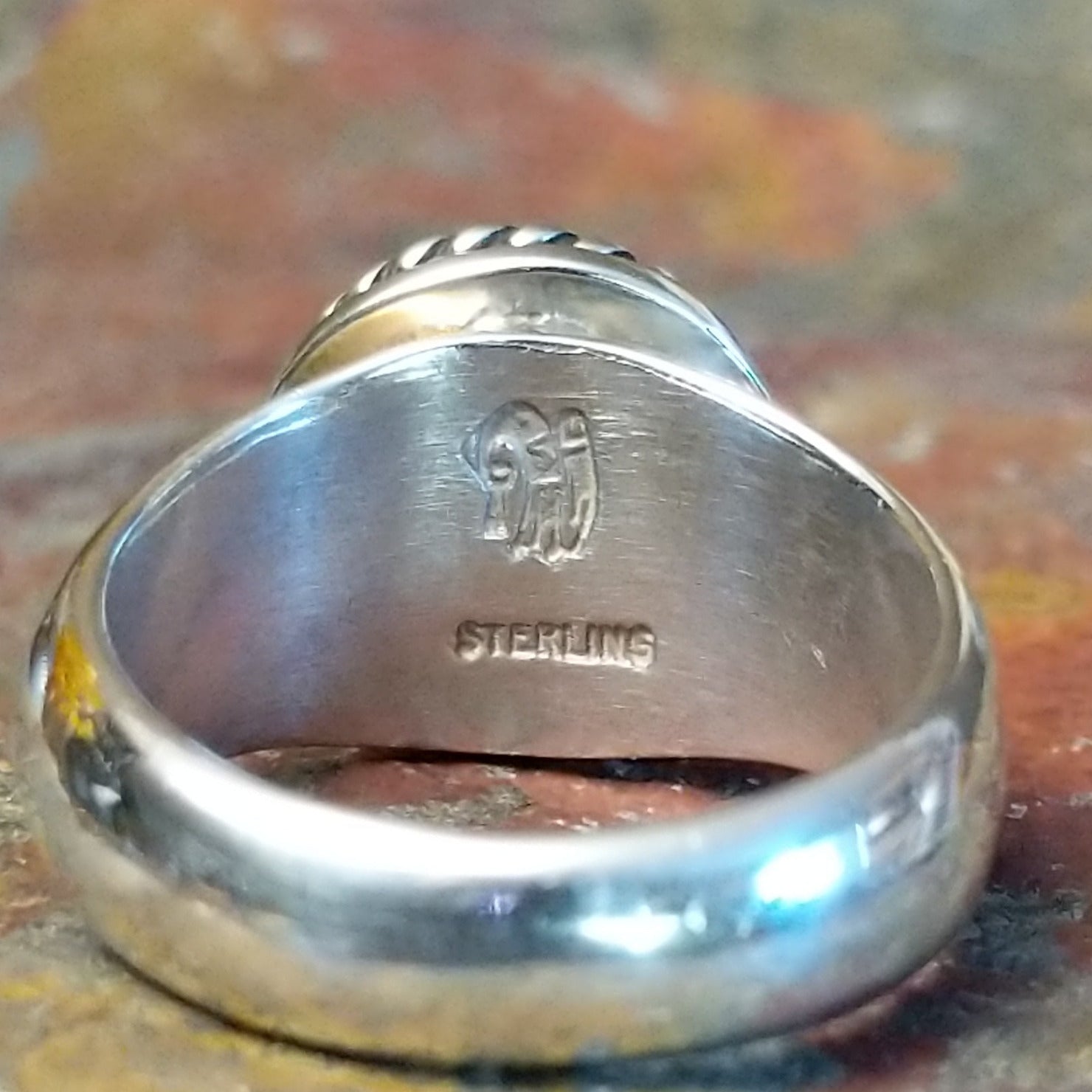 A close-up of the authentication stamp on the interior of the band.