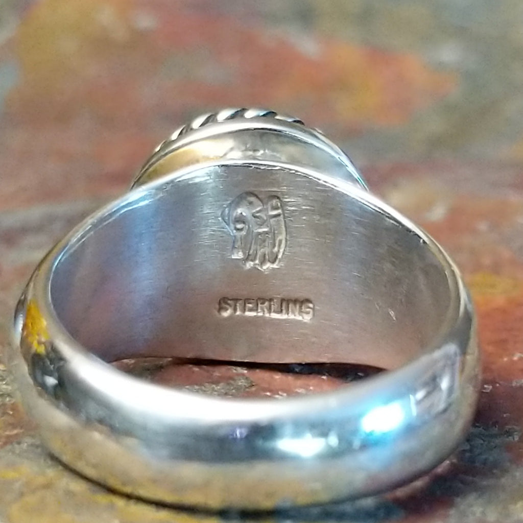 A close-up of the authentication stamp on the interior of the band.