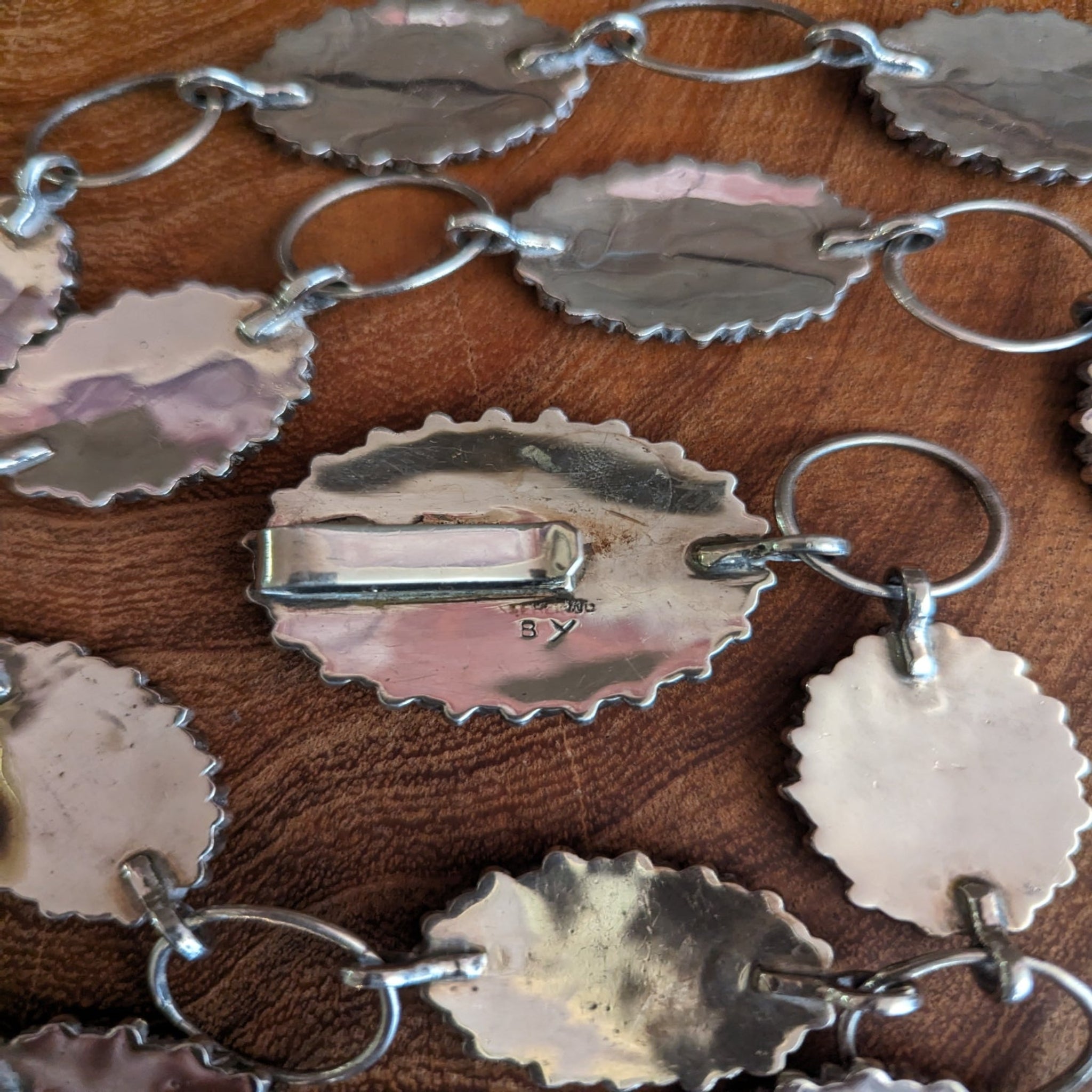 artist mark on buckle of coral concho belt
