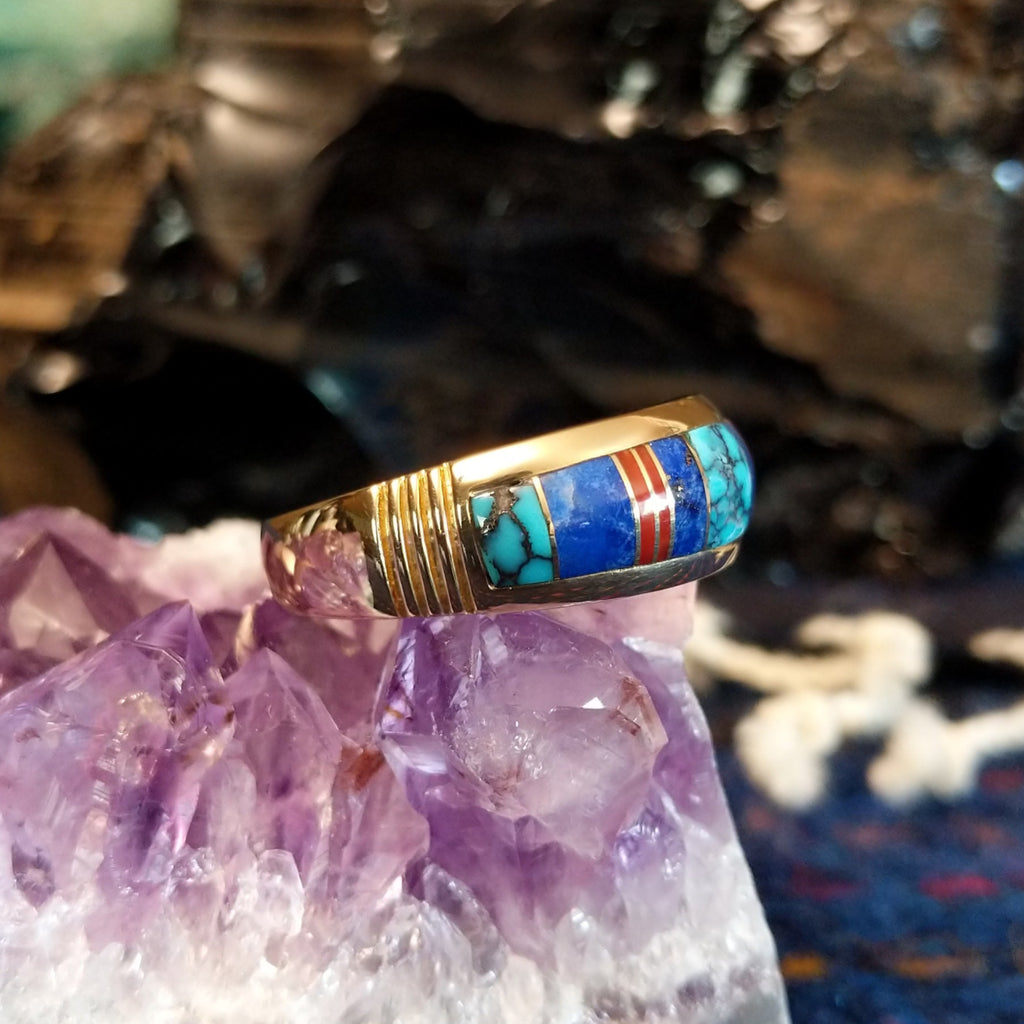 Navajo-crafted gold ring featuring inlay work in turquoise, lapis lazuli, and red coral.