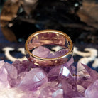 The polished gold band of the ring.