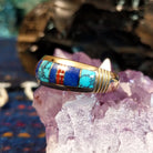 Navajo-crafted gold ring featuring inlay work in turquoise, lapis lazuli, and red coral.