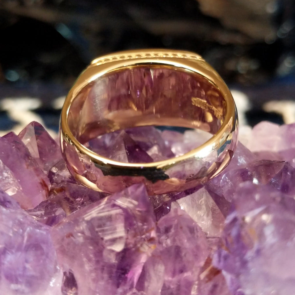 The polished gold band of the ring.