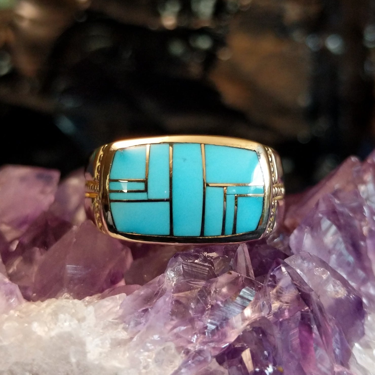 Gold ring featuring a rectangular turquoise inlay set in 14k gold.