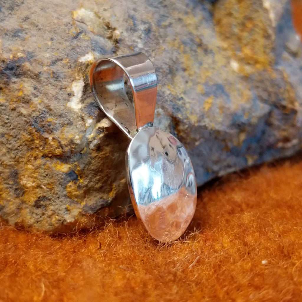 Sterling silver pendant hammered in a smooth, thin appearance.