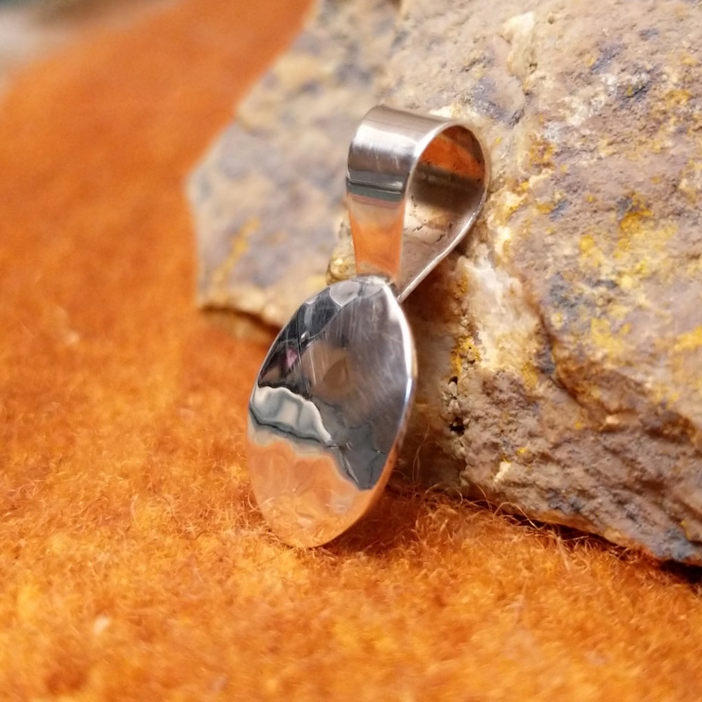 Sterling silver pendant hammered in a smooth, thin appearance.