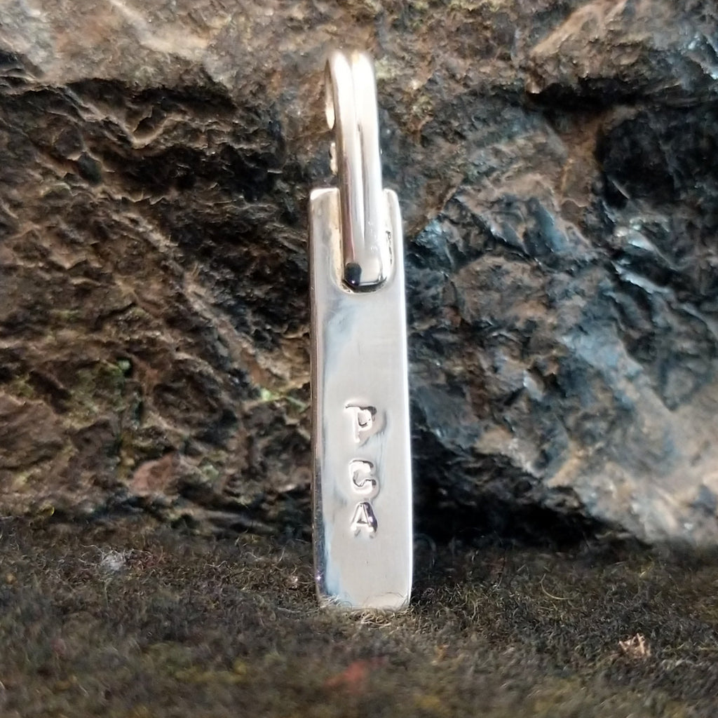 The initials P.C.A are stamped on the back.