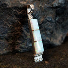 Manmade opal inlaid in sterling silver in the shape of a bar.