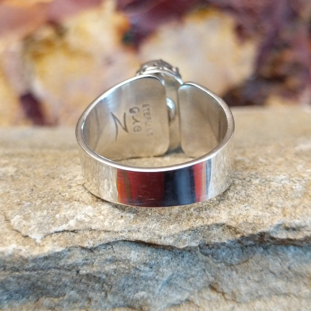 Smooth, tapered sterling silver band of the ring.