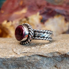 Purple spiny oyster shell set in a twisted rope bezel.