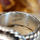 The authentication stamp is on the inside of the band.