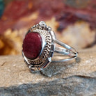 Purple spiny oyster set in an ornate bezel with twisted rope, stars, and various incisions.