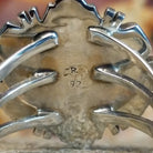 The authentication stamp is on the underside of the bezel.