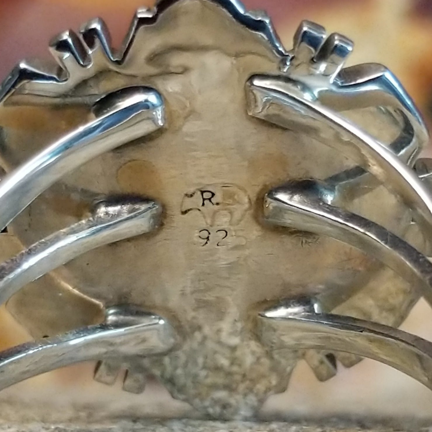 The authentication stamp is on the underside of the bezel.