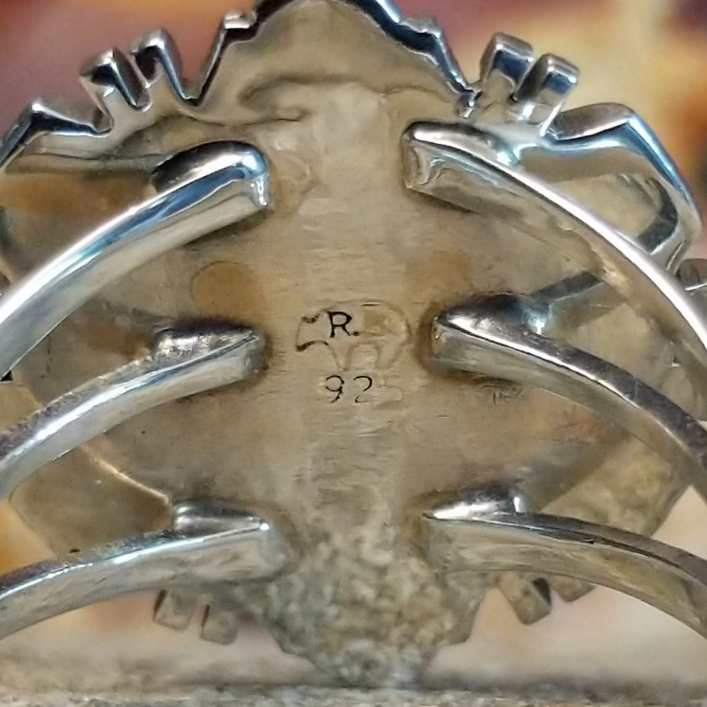 The authentication stamp is on the underside of the bezel.