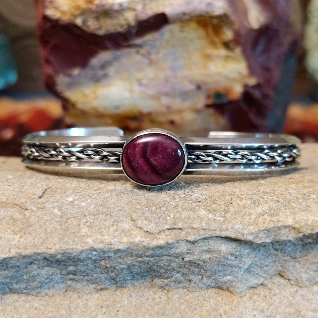 Navajo cuff features a polished purple spiny oyster shell centerpiece, framed by intricate sterling silver chain work.
