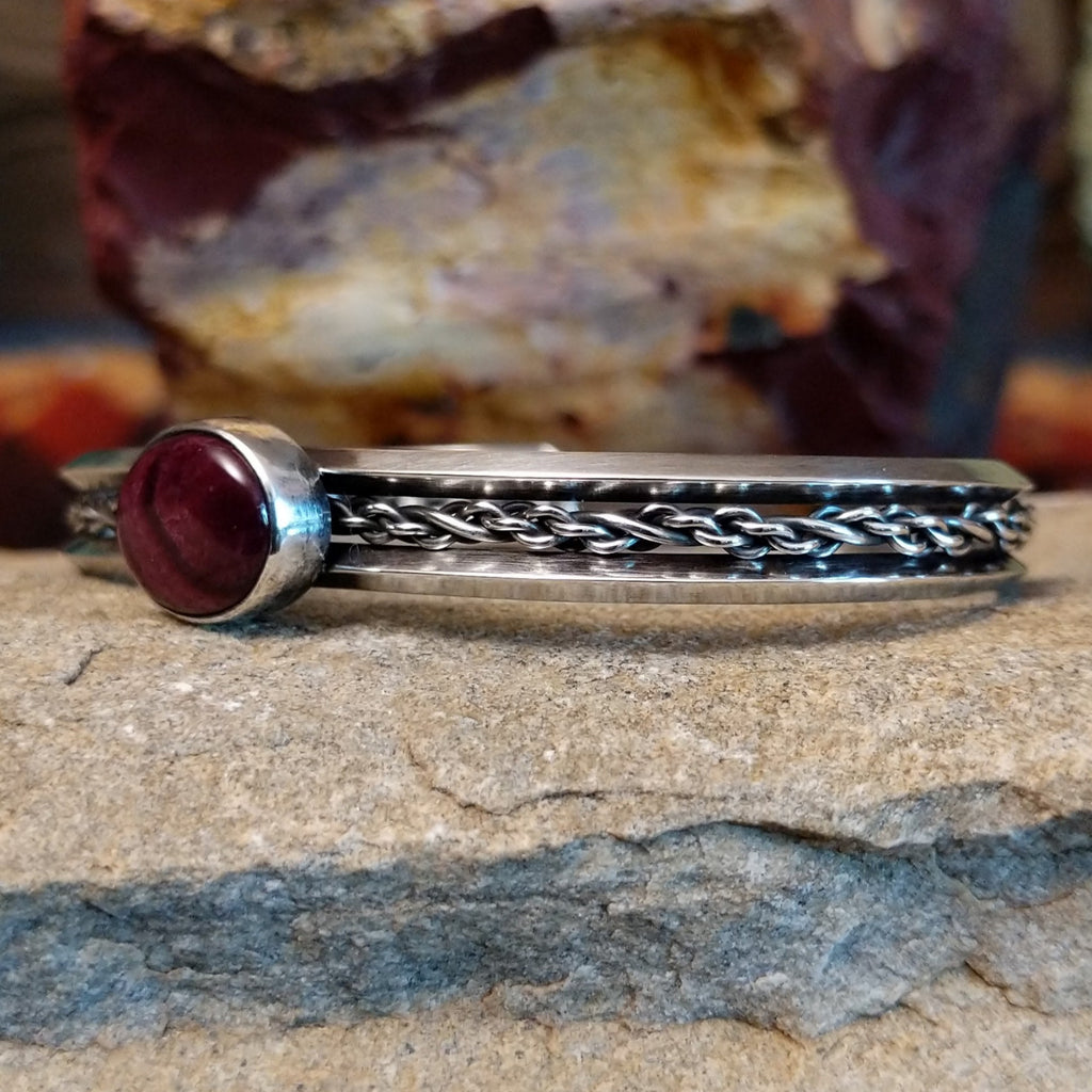 Navajo cuff features a polished purple spiny oyster shell centerpiece, framed by intricate sterling silver chain work.