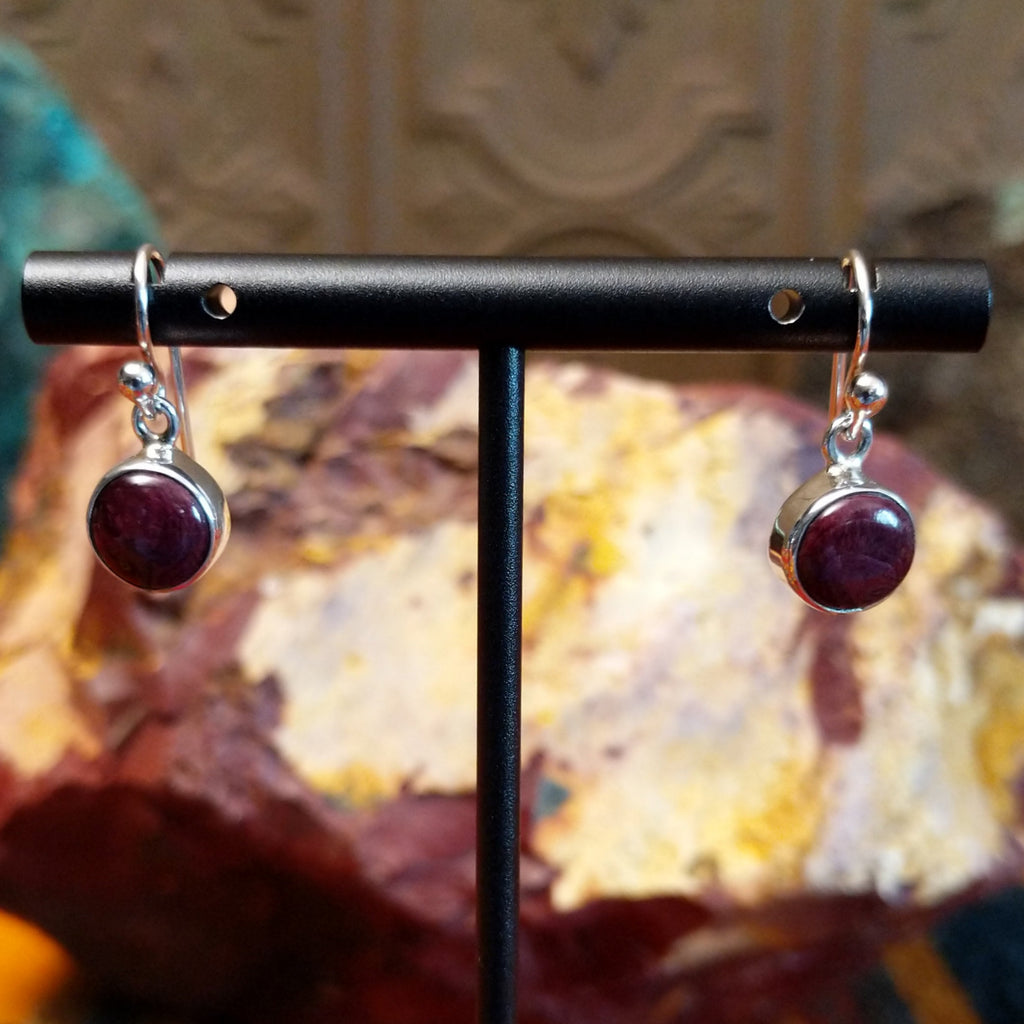 Small circular purple spiny oyster shell set in sterling silver with dangle hooks.