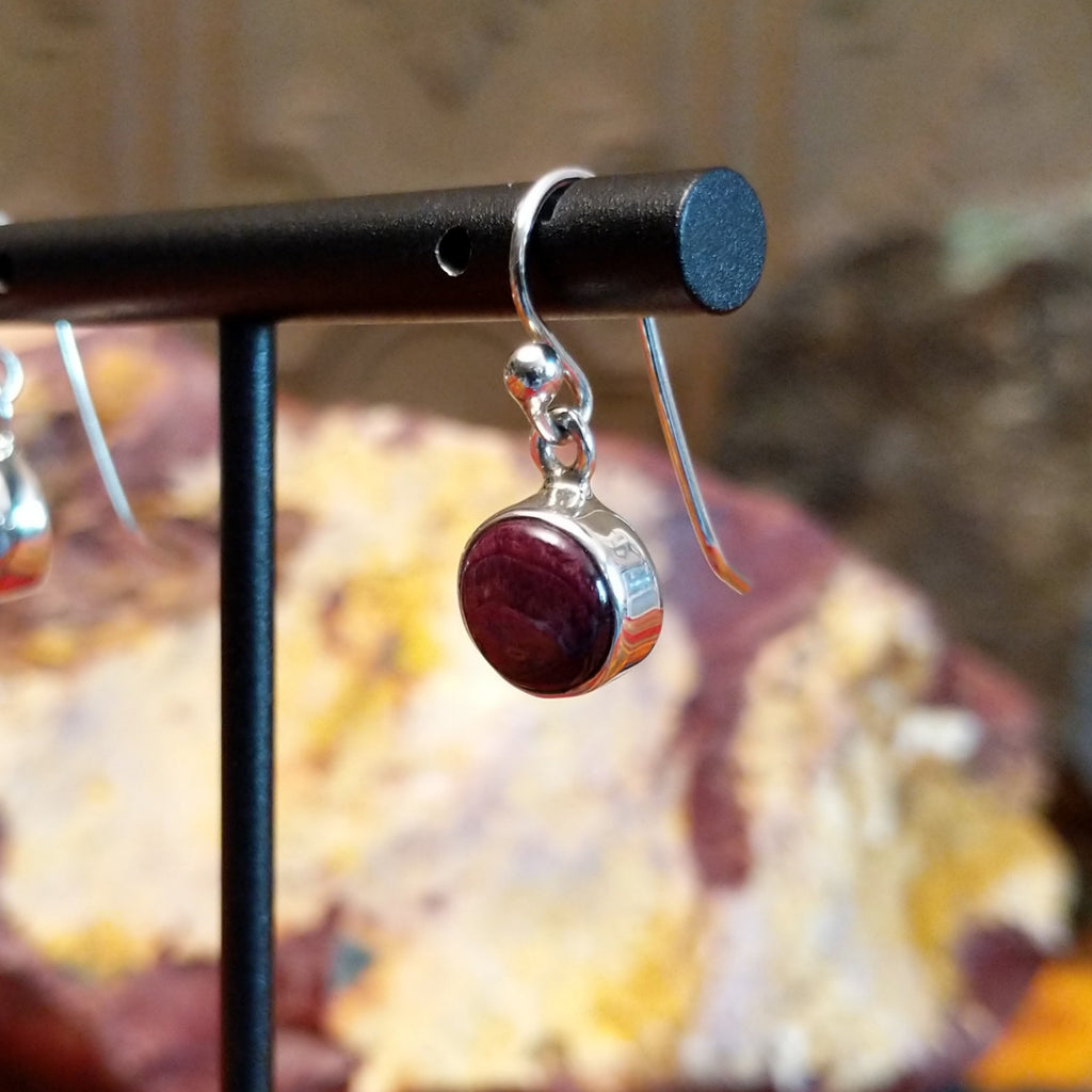 Small circular purple spiny oyster shell set in sterling silver with dangle hooks.