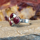 Four purple spiny oyster shells clustered together on a thin sterling silver band.