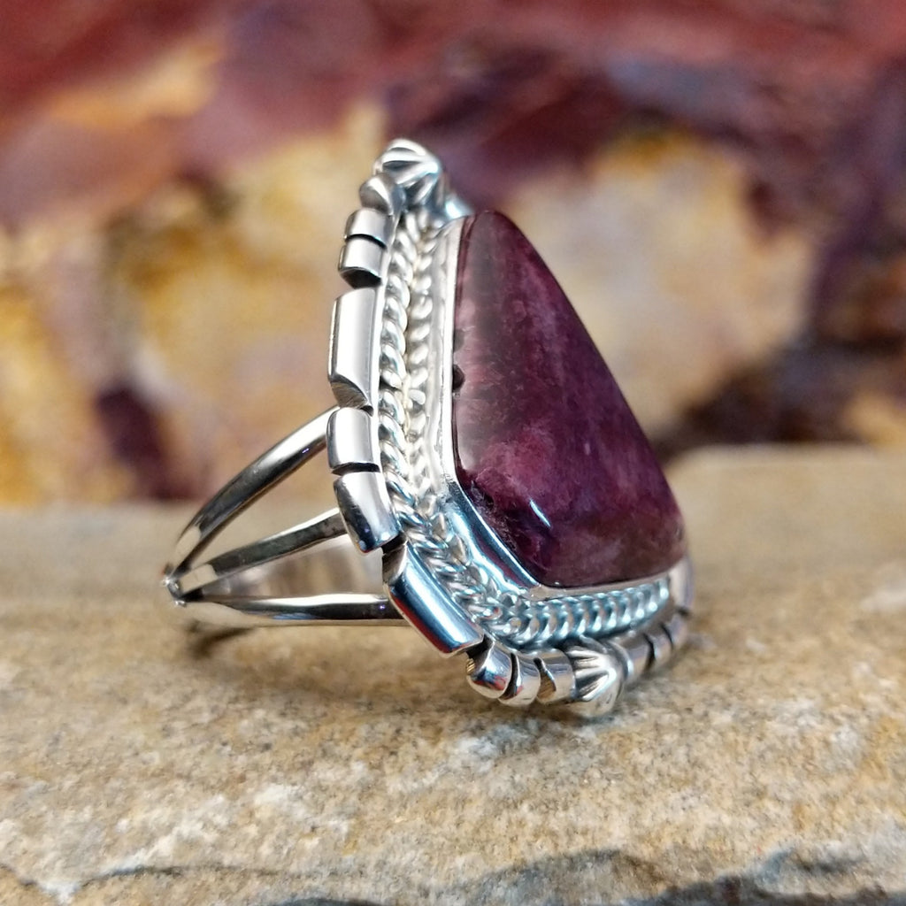 Triangular purple spiny oyster shell with intricate incised and twisted rope setting.