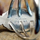 The authentication stamp is found on the underside of the bezel.