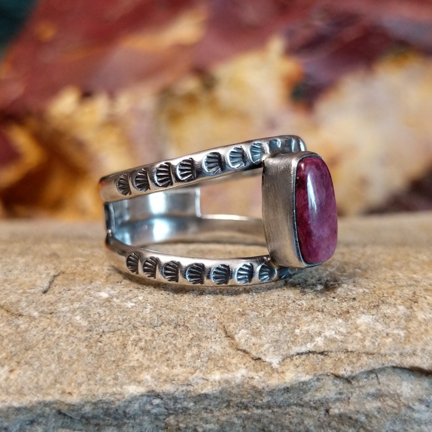 Open, layered sterling silver band with stamping and a purple spiny oyster centerpiece.