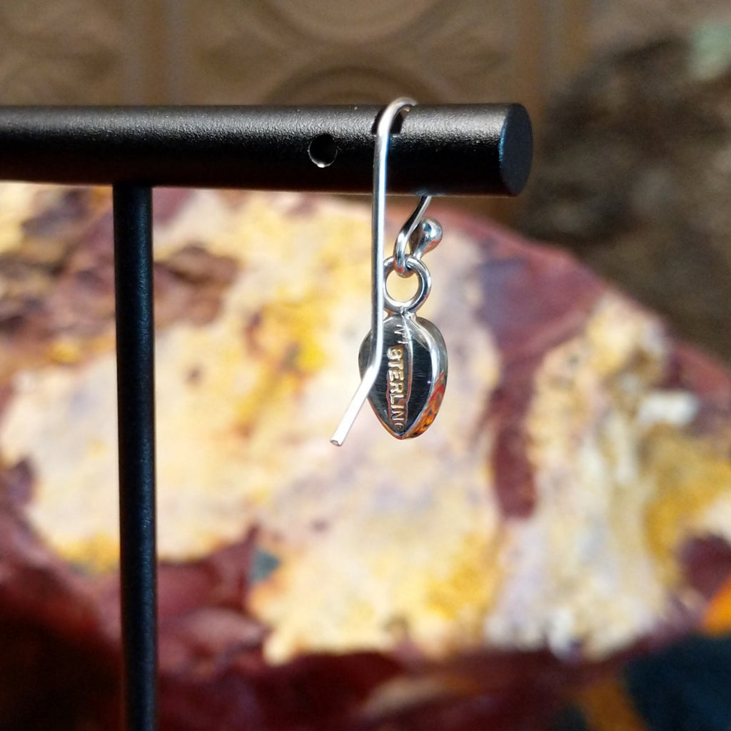 The authentication stamp is found on the back of the earrings.