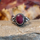 Purple spiny oyster shell ring with twisted rope accents and dot work.