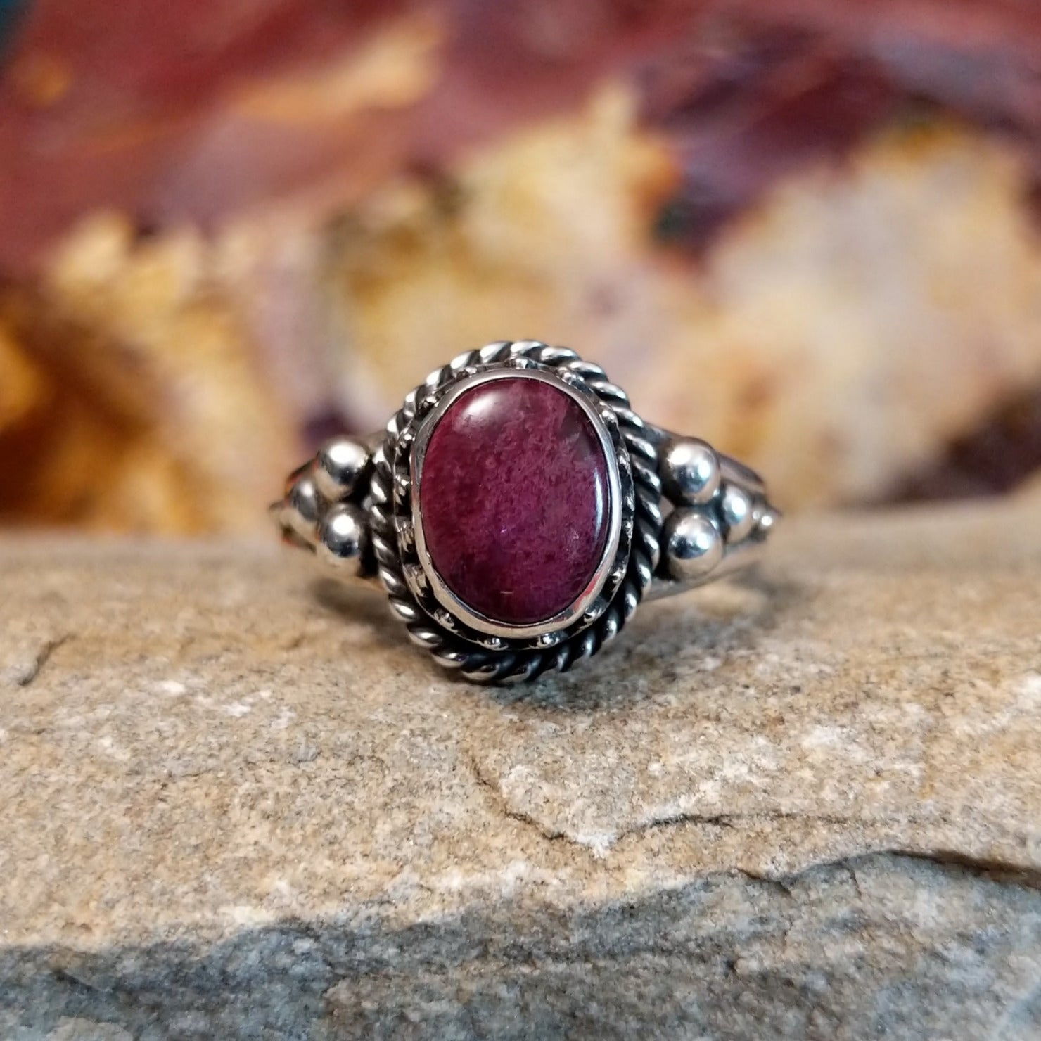 Purple spiny oyster shell ring with twisted rope accents and dot work.